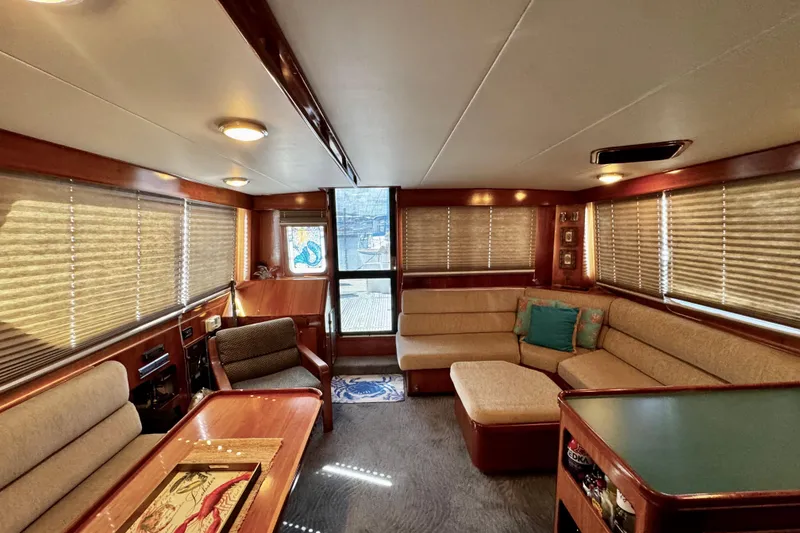 Slide: The Image of Luxurious interior of 1998 Mikelson 43 Sportfisher yacht with plush seating and elegant wood finishes. - 11