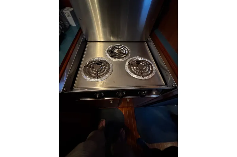 Slide: The Image of Stainless steel stove with three burners on a 1998 Mikelson 43 Sportfisher yacht. - 13