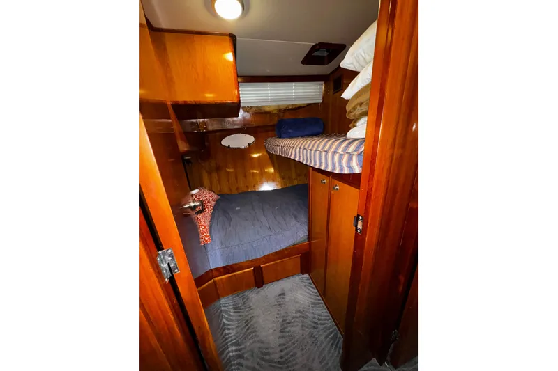 Slide: The Image of Cozy cabin interior of 1998 Mikelson 43 Sportfisher with wooden finish and bunk beds. - 17