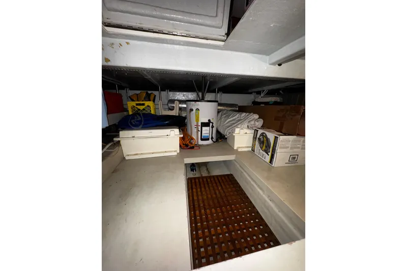 Slide: The Image of Storage area in a 1998 Mikelson 43 Sportfisher boat, featuring various equipment and supplies. - 20