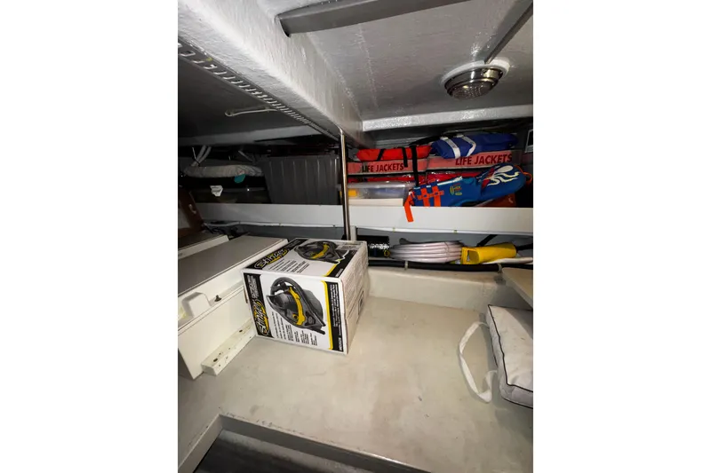 Slide: The Image of Storage area in 1998 Mikelson 43 Sportfisher with life jackets and equipment. - 22