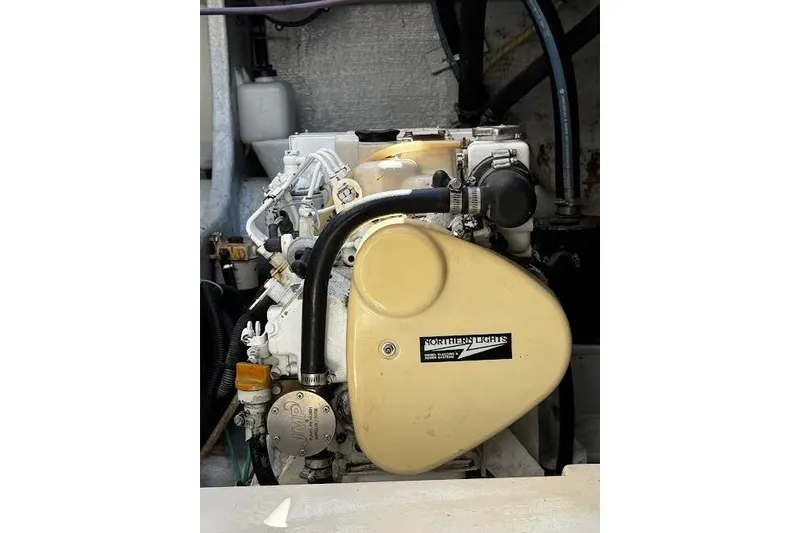 Slide: The Image of Engine of a 1998 Mikelson 43 Sportfisher boat, featuring Northern Lights components. - 25