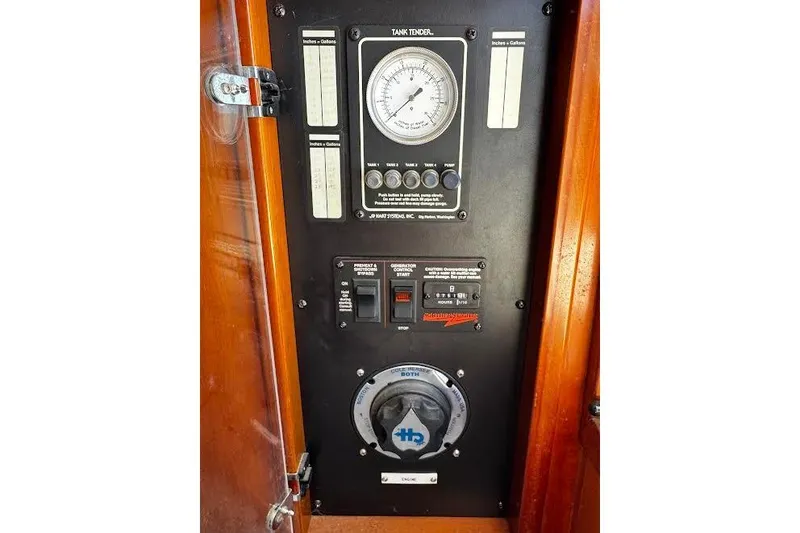 Slide: The Image of Control panel of 1998 Mikelson 43 Sportfisher boat, featuring gauges and switches. - 27