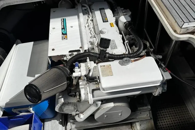 Slide: The Image of Engine compartment of a 1998 Mikelson 43 Sportfisher boat, showcasing detailed components. - 28