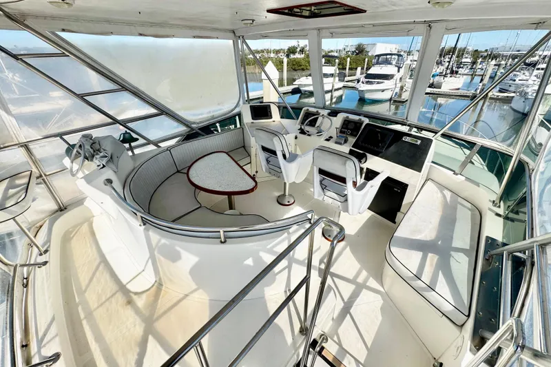 Slide: The Image of Cockpit of 1998 Mikelson 43 Sportfisher with seating and navigation equipment, docked at marina. - 7