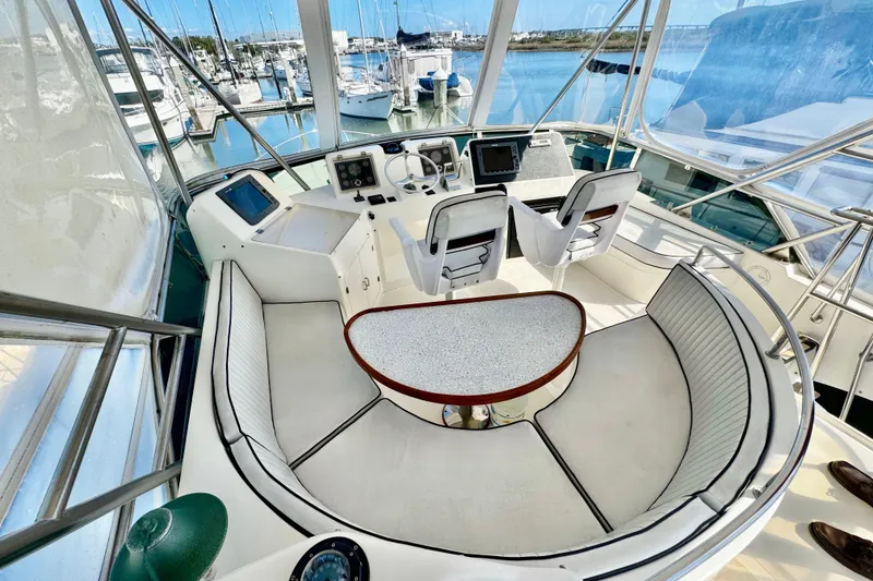 Slide: The Image of Cockpit of 1998 Mikelson 43 Sportfisher with seating and navigation equipment, docked at marina. - 8