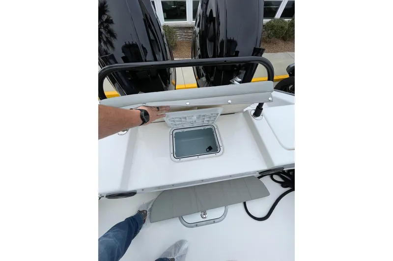 Slide: The Image of 2023 Cape Horn 24 XS boat interior with storage compartment and dual engines. - 10