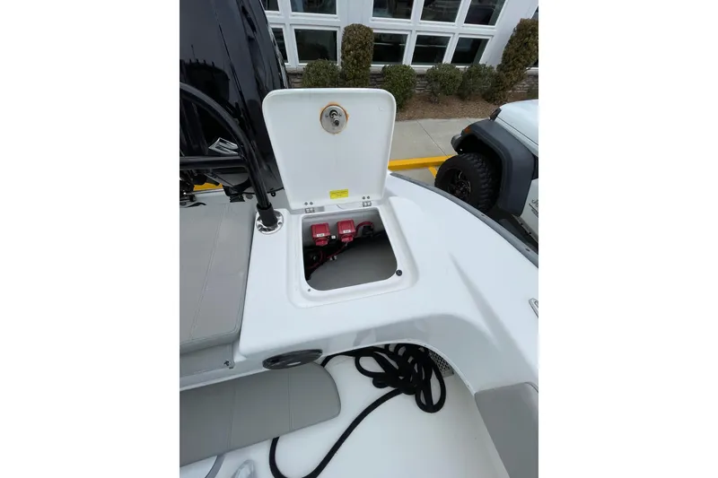 Slide: The Image of 2023 Cape Horn 24 XS boat battery compartment with open hatch, showcasing interior components. - 11