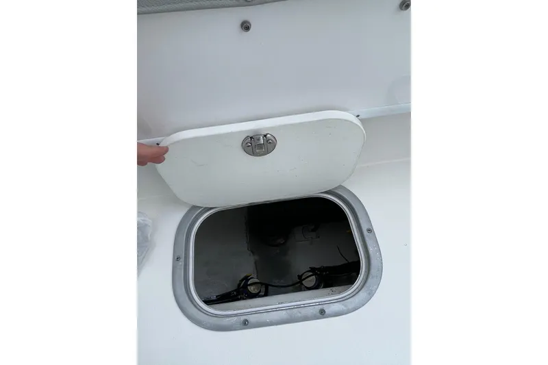 Slide: The Image of 2023 Cape Horn 24 XS boat hatch open, revealing interior compartment. - 12