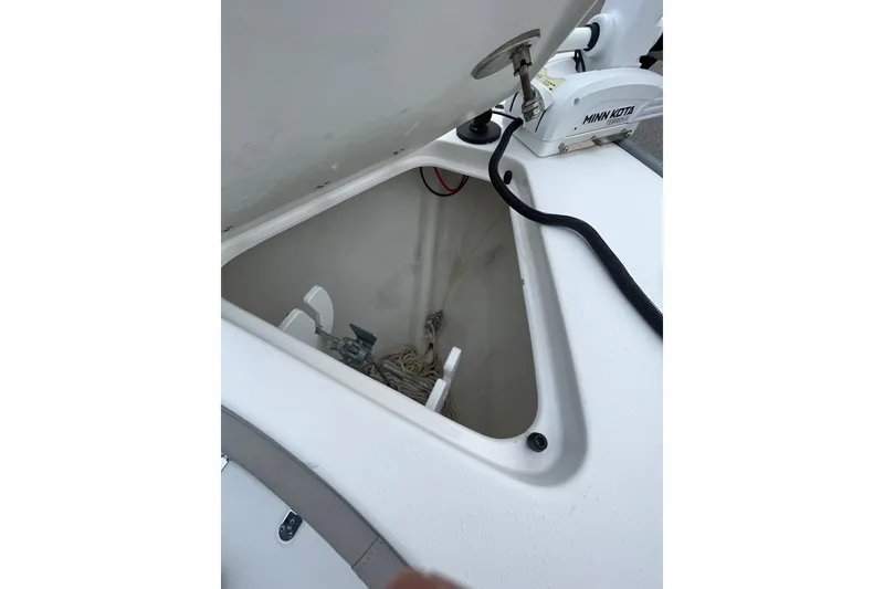 Slide: The Image of Open storage compartment on 2023 Cape Horn 24 XS boat with Minn Kota equipment. - 16