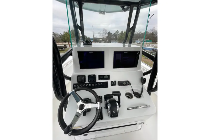 Slide: The Image of 2023 Cape Horn 24 XS boat console with steering wheel and electronic controls. - 6