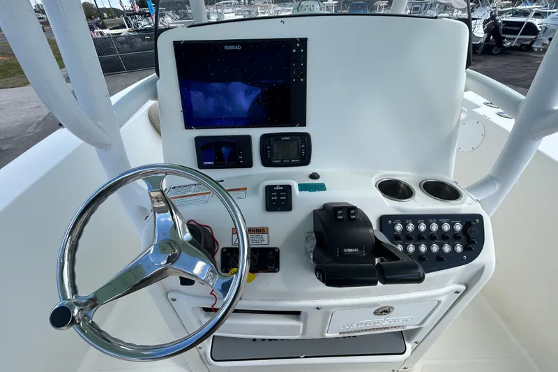 Slide: The Image of 2018 NauticStar 28 XS boat console with steering wheel and navigation controls. - 21