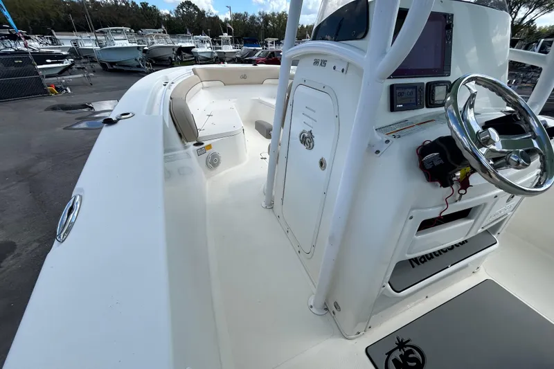 Slide: The Image of 2018 NauticStar 28 XS boat interior with steering console and seating area. - 22