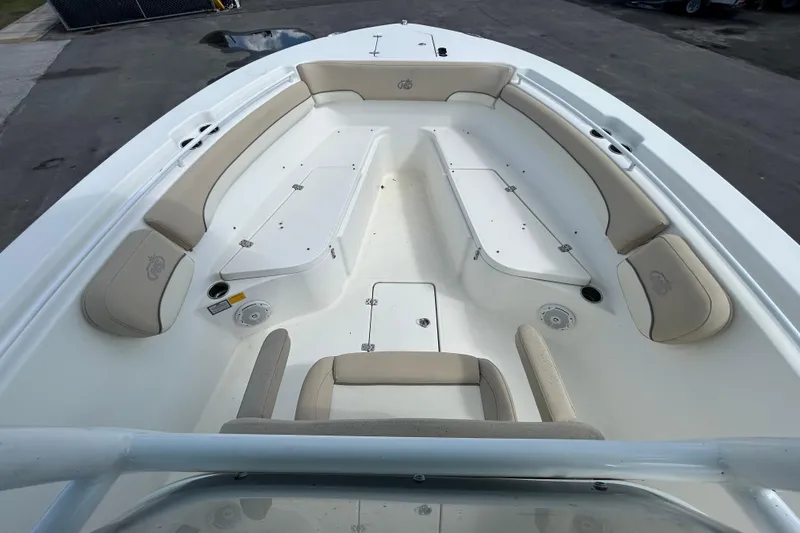 Slide: The Image of 2018 NauticStar 28 XS boat interior with beige seating and storage compartments. - 24