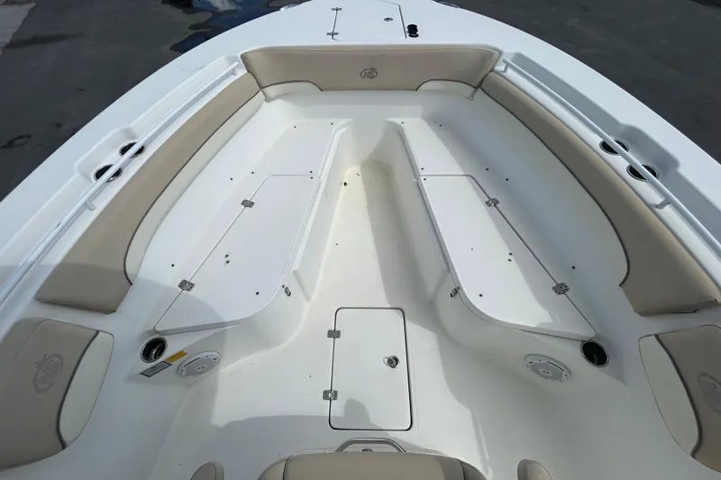 Slide: The Image of 2018 NauticStar 28 XS boat interior with beige seating and storage compartments. - 25