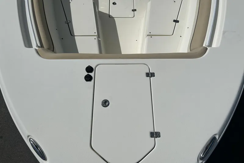 Slide: The Image of 2018 NauticStar 28 XS boat deck with storage compartments and seating area. - 27