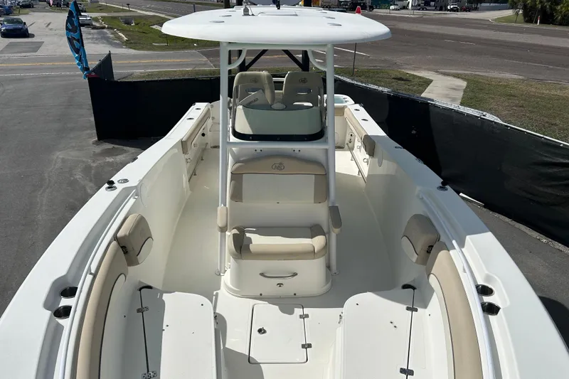 Slide: The Image of 2018 NauticStar 28 XS boat with spacious deck and seating, parked outdoors. - 29