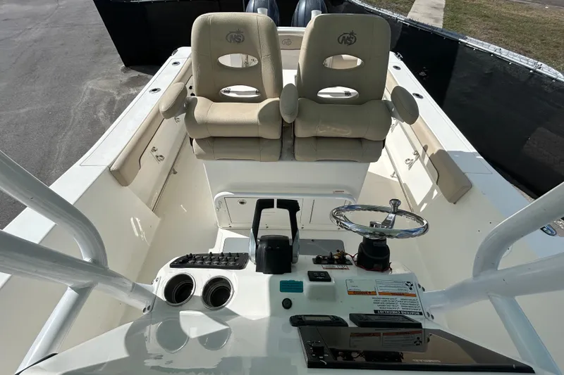Slide: The Image of 2018 NauticStar 28 XS boat interior with dual seats and steering console. - 35