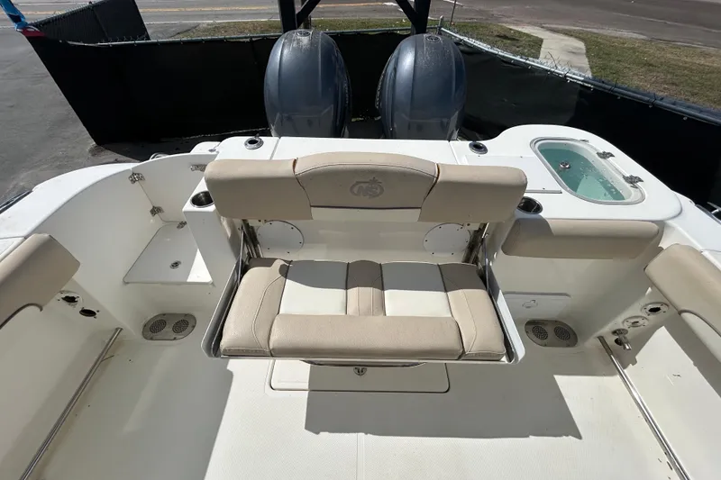 Slide: The Image of 2018 NauticStar 28 XS boat interior with seating and dual engines. - 37