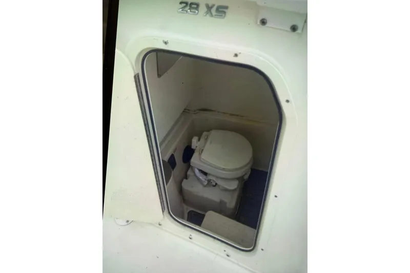 Slide: The Image of 2018 NauticStar 28 XS boat on trailer under a partly cloudy sky. - 4