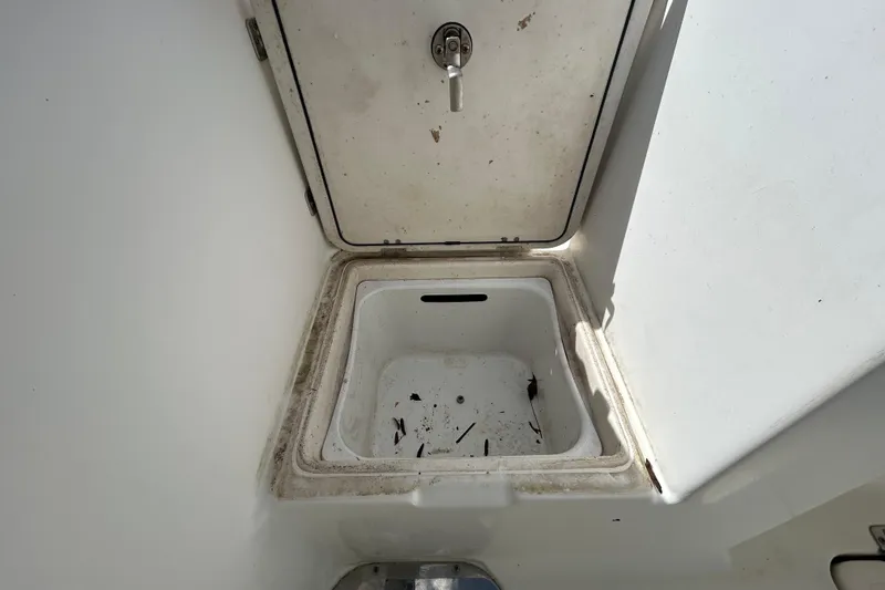 Slide: The Image of Open storage compartment on 2018 NauticStar 28 XS boat, showing interior details. - 41