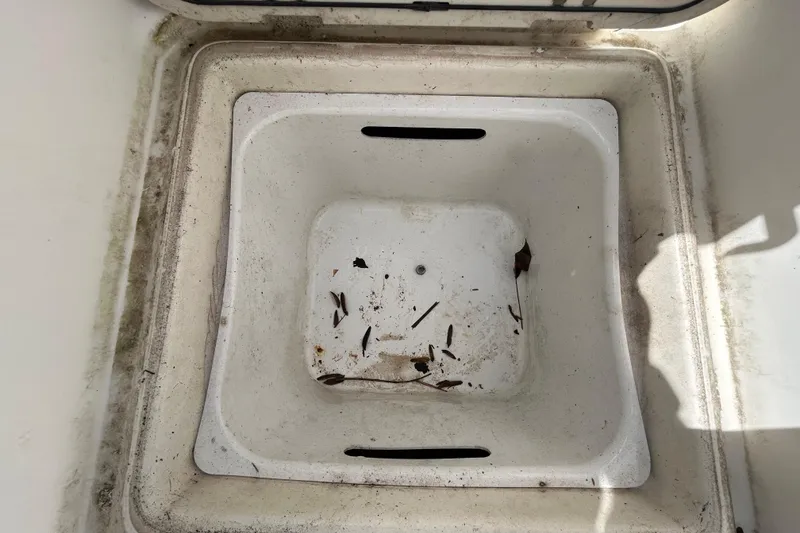 Slide: The Image of 2018 NauticStar 28 XS boat compartment with debris and dirt. - 42