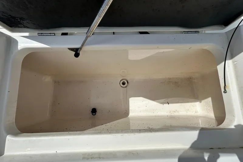 Slide: The Image of Open storage compartment on 2018 NauticStar 28 XS boat, showing interior details. - 45