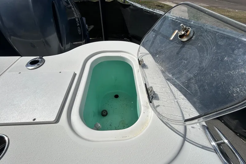 Slide: The Image of 2018 NauticStar 28 XS boat livewell with open lid and clean interior. - 47
