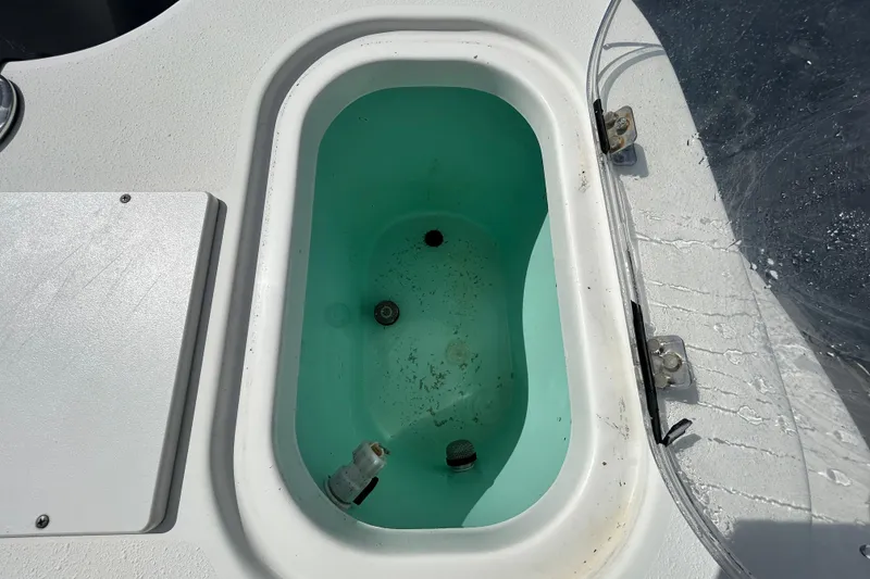 Slide: The Image of Livewell on 2018 NauticStar 28 XS boat, featuring clean interior and secure latches. - 48