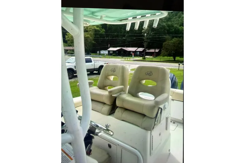 Slide: The Image of 2018 NauticStar 28 XS boat on trailer under a partly cloudy sky. - 5