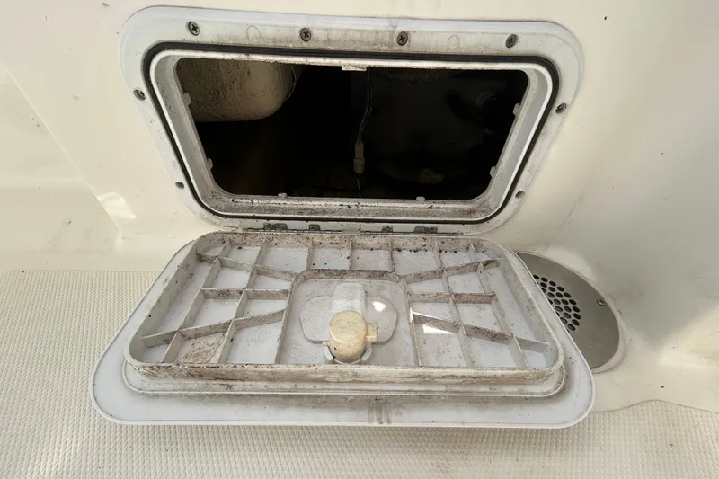 Slide: The Image of Open hatch on 2018 NauticStar 28 XS boat, showing interior compartment. - 50
