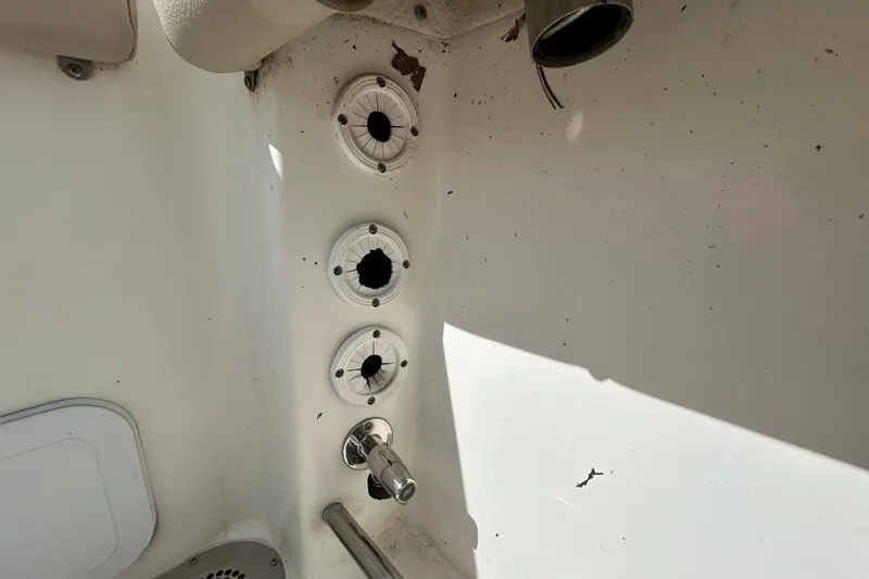 Slide: The Image of 2018 NauticStar 28 XS boat interior with rod holders and metal fixtures. - 52