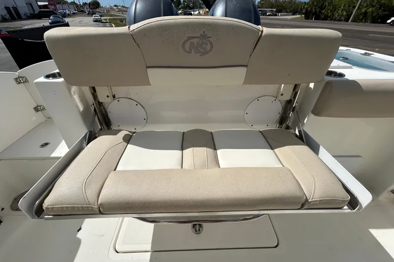 Slide: The Image of 2018 NauticStar 28 XS boat seat with beige upholstery, showcasing comfort and style. - 53