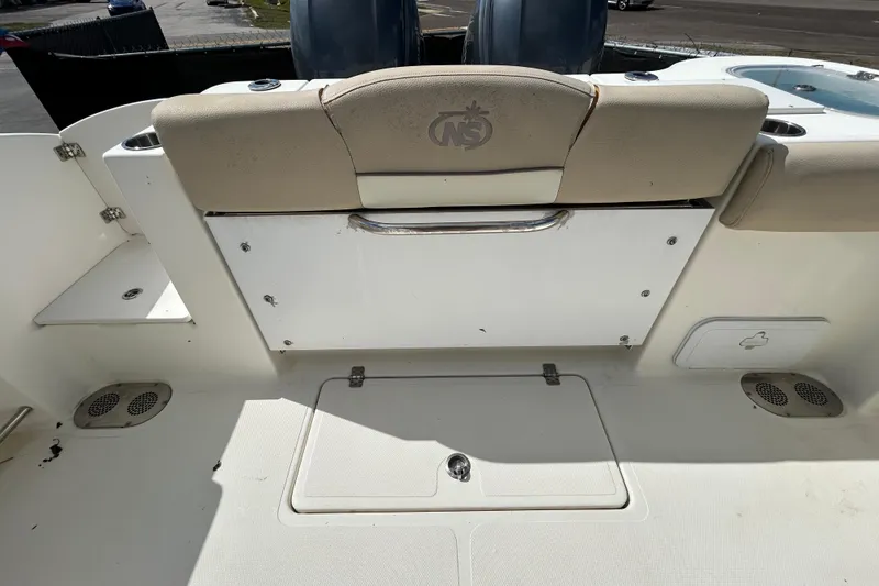 Slide: The Image of 2018 NauticStar 28 XS boat interior with seating and storage compartments. - 54