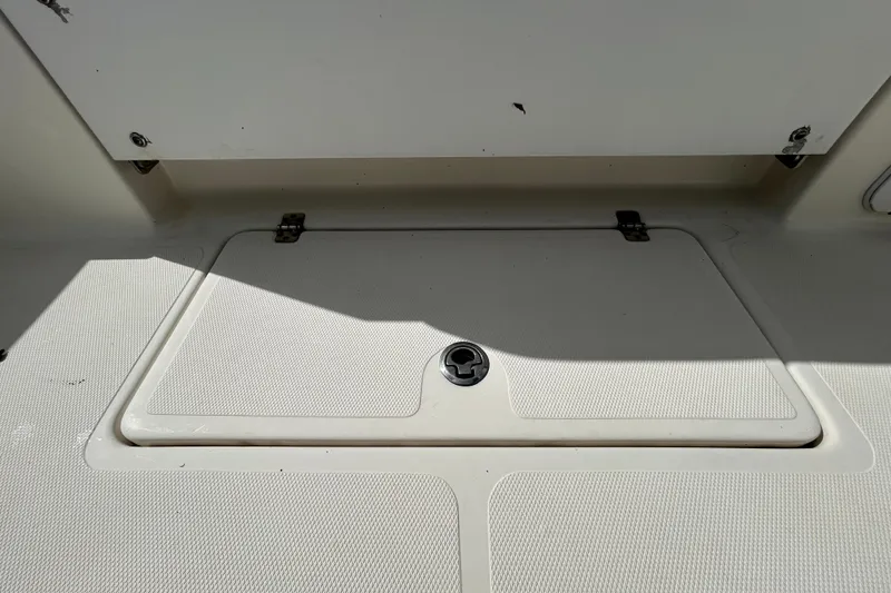 Slide: The Image of 2018 NauticStar 28 XS boat storage compartment with secure latch. - 55