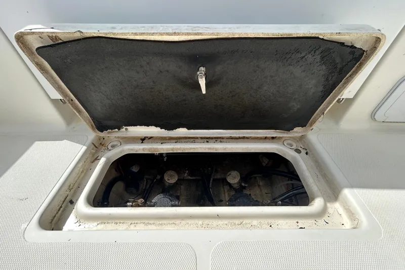 Slide: The Image of Open hatch of 2018 NauticStar 28 XS boat, revealing internal components. - 56