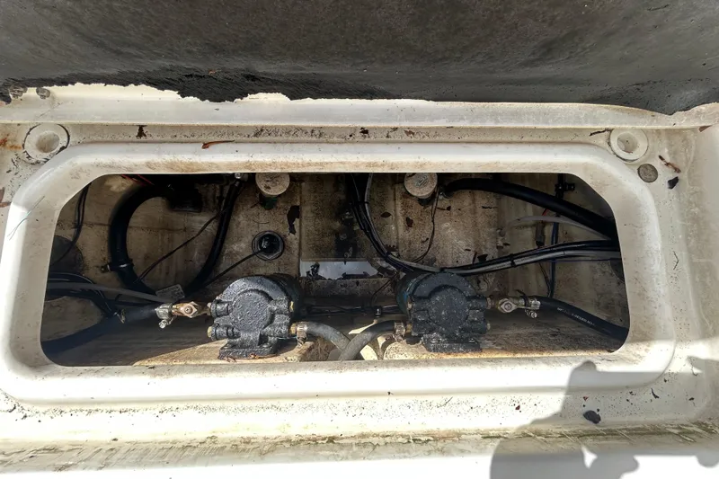 Slide: The Image of 2018 NauticStar 28 XS boat compartment with visible wiring and components. - 57