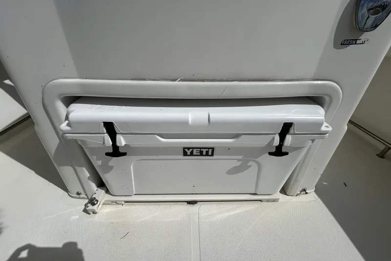 Slide: The Image of YETI cooler on 2018 NauticStar 28 XS boat, integrated storage compartment. - 58