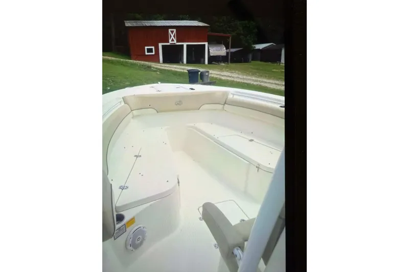 Slide: The Image of 2018 NauticStar 28 XS boat on trailer, viewed from below against blue sky. - 6