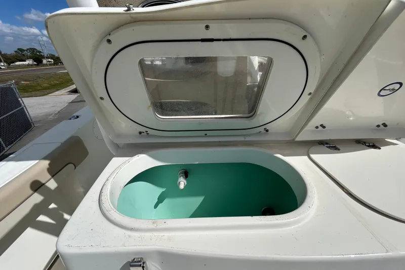 Slide: The Image of 2018 NauticStar 28 XS boat livewell with open hatch and clear window. - 62