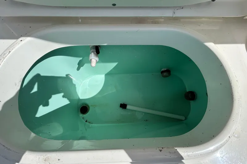 Slide: The Image of Livewell in 2018 NauticStar 28 XS boat, partially filled with water. - 63