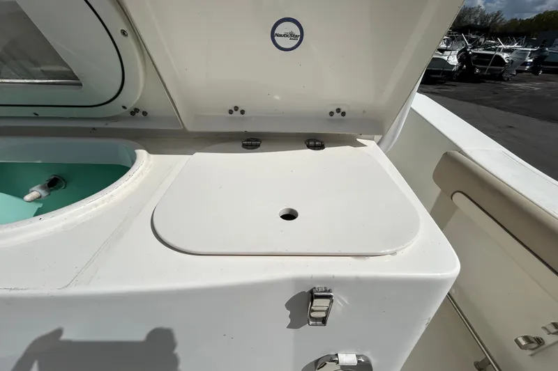 Slide: The Image of 2018 NauticStar 28 XS boat deck with storage compartment and livewell. - 64