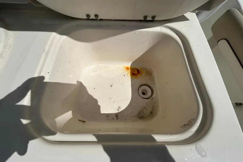 Slide: The Image of Dirty sink on 2018 NauticStar 28 XS boat with rust and stains. - 66