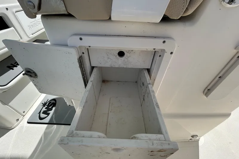Slide: The Image of Open storage compartment on a 2018 NauticStar 28 XS boat. - 69