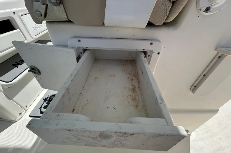 Slide: The Image of Open storage compartment on a 2018 NauticStar 28 XS boat, showing interior details. - 70