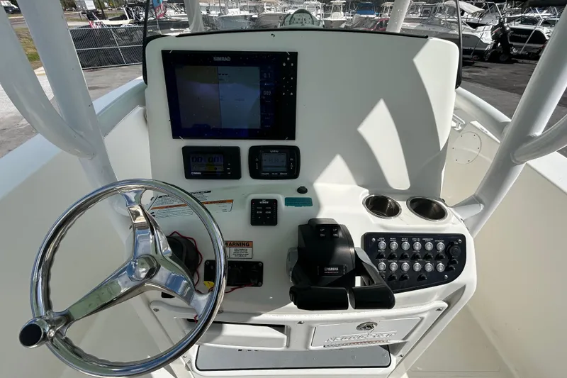 Slide: The Image of 2018 NauticStar 28 XS boat dashboard with steering wheel and control panel. - 74