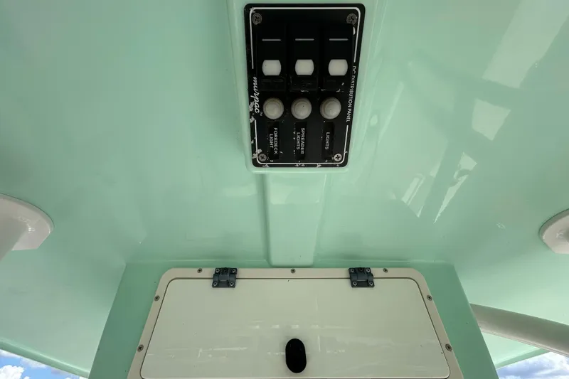 Slide: The Image of 2018 NauticStar 28 XS boat control panel with switches and light controls. - 76