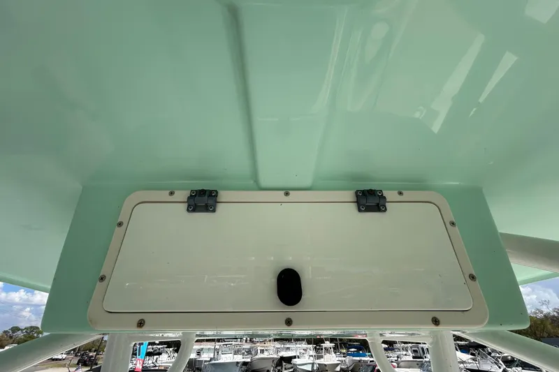 Slide: The Image of 2018 NauticStar 28 XS boat storage compartment with light green interior. - 77
