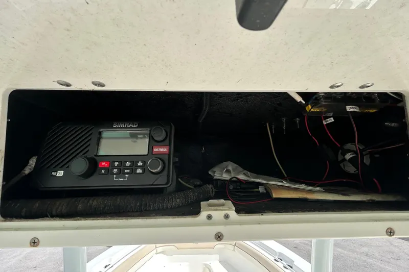 Slide: The Image of 2018 NauticStar 28 XS boat electronics compartment with Simrad RS35 radio. - 79