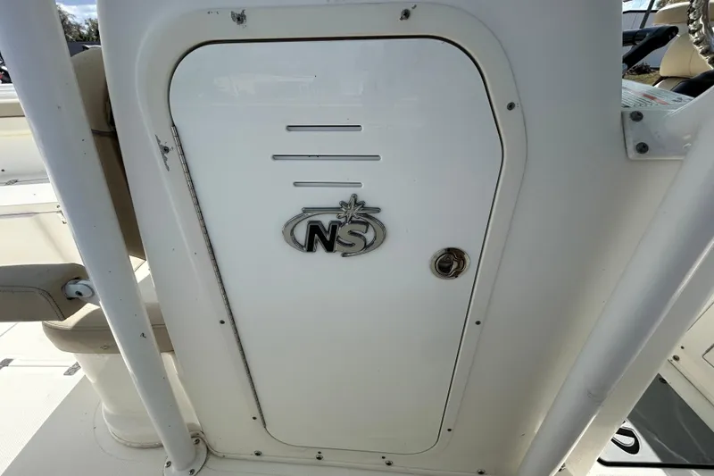 Slide: The Image of 2018 NauticStar 28 XS boat compartment door with NS logo. - 80